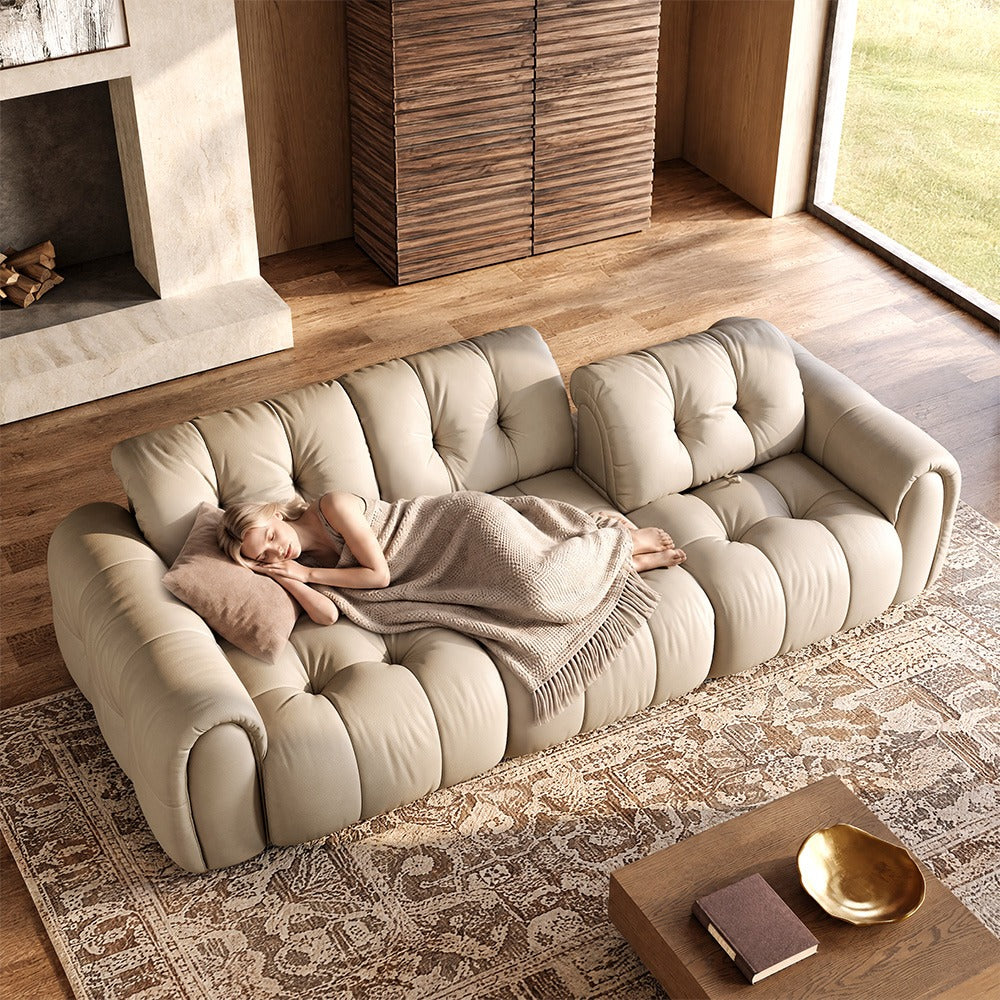119.5-inch beige top-grain leather tufted modular sofa in a living room