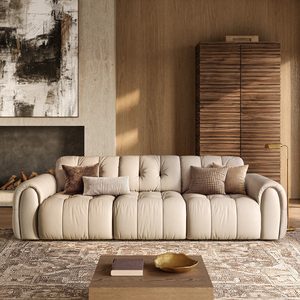 119.5-inch beige leather tufted sofa in a living room, front view
