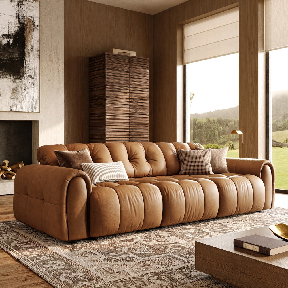Brown leather tufted modular sofa with three armless seats and two armrests, front view in a living room