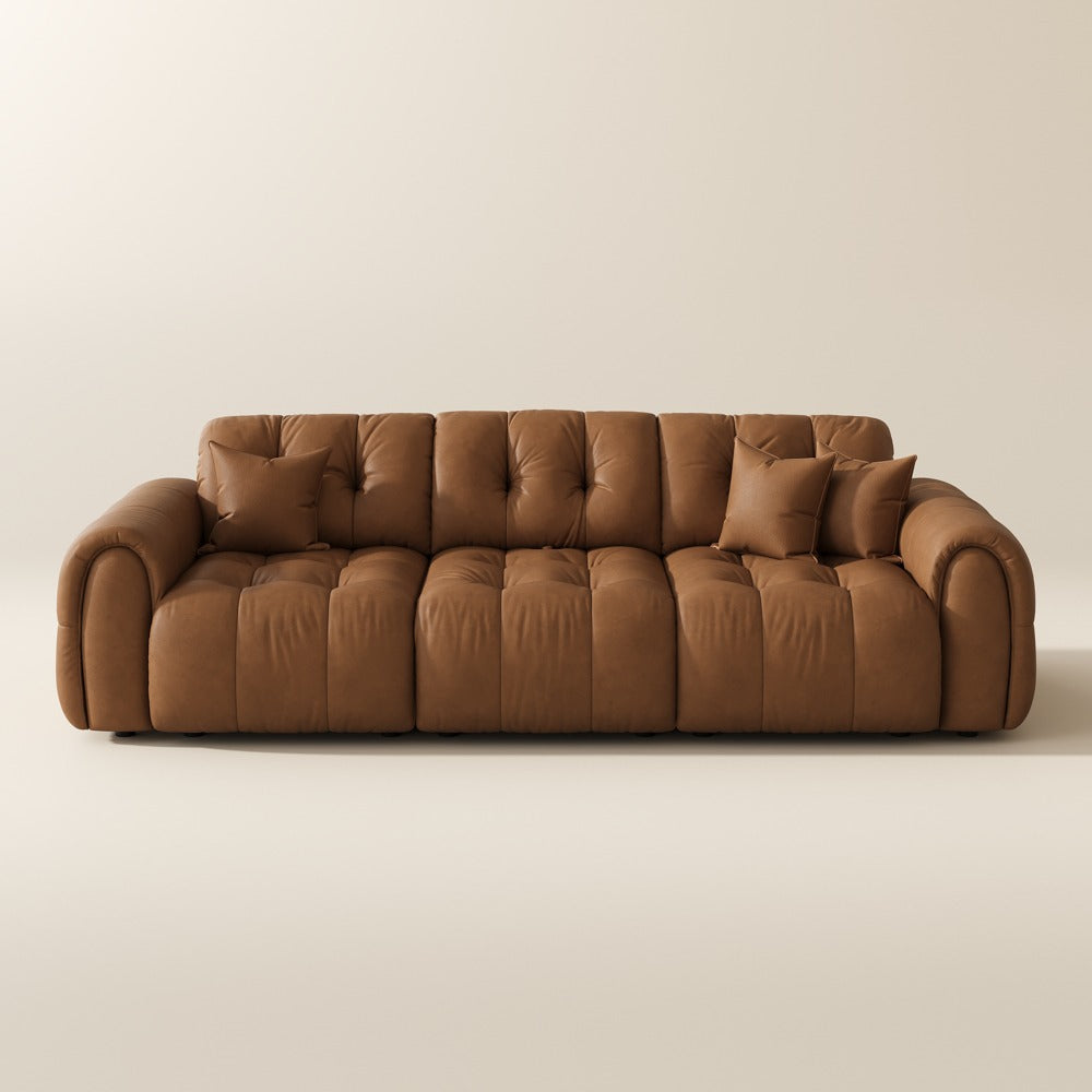 119.5-inch brown top-grain leather tufted modular sofa with pillows on a plain background