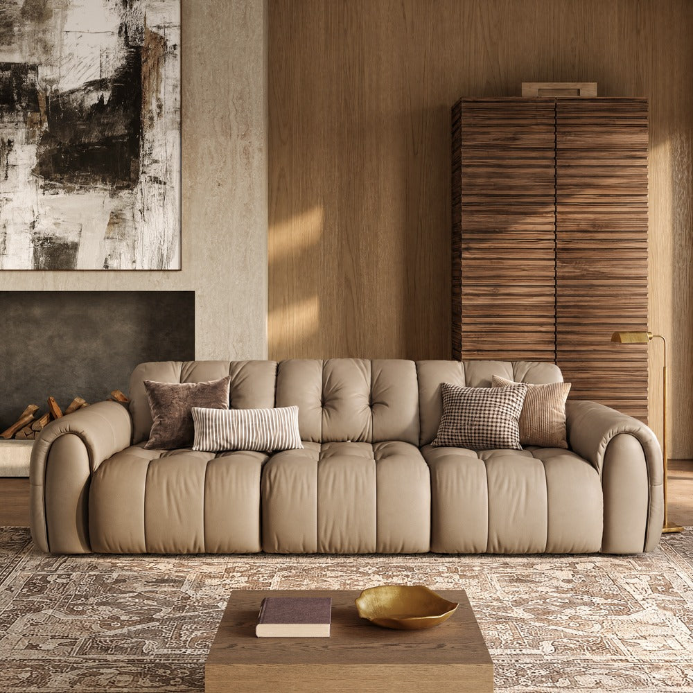 119.5-inch khaki leather tufted sofa in a living room, front view