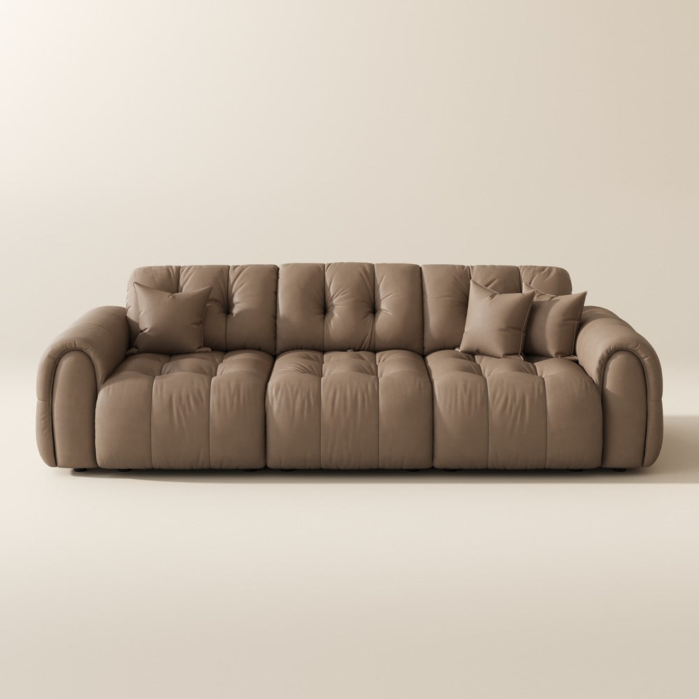 119.5-inch khaki top-grain leather tufted modular sofa with pillows on a plain background