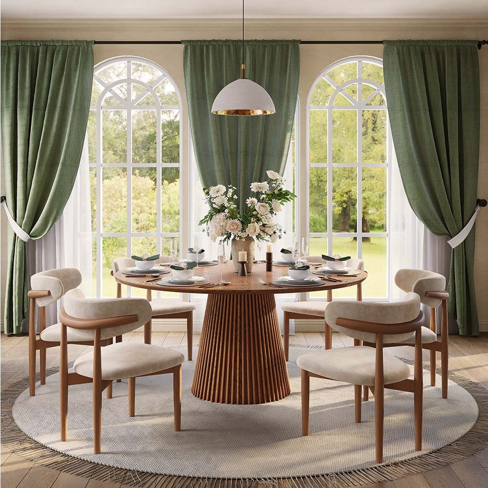 Round walnut-finish dining table with fluted pedestal, front view in a dining room (chairs not included)