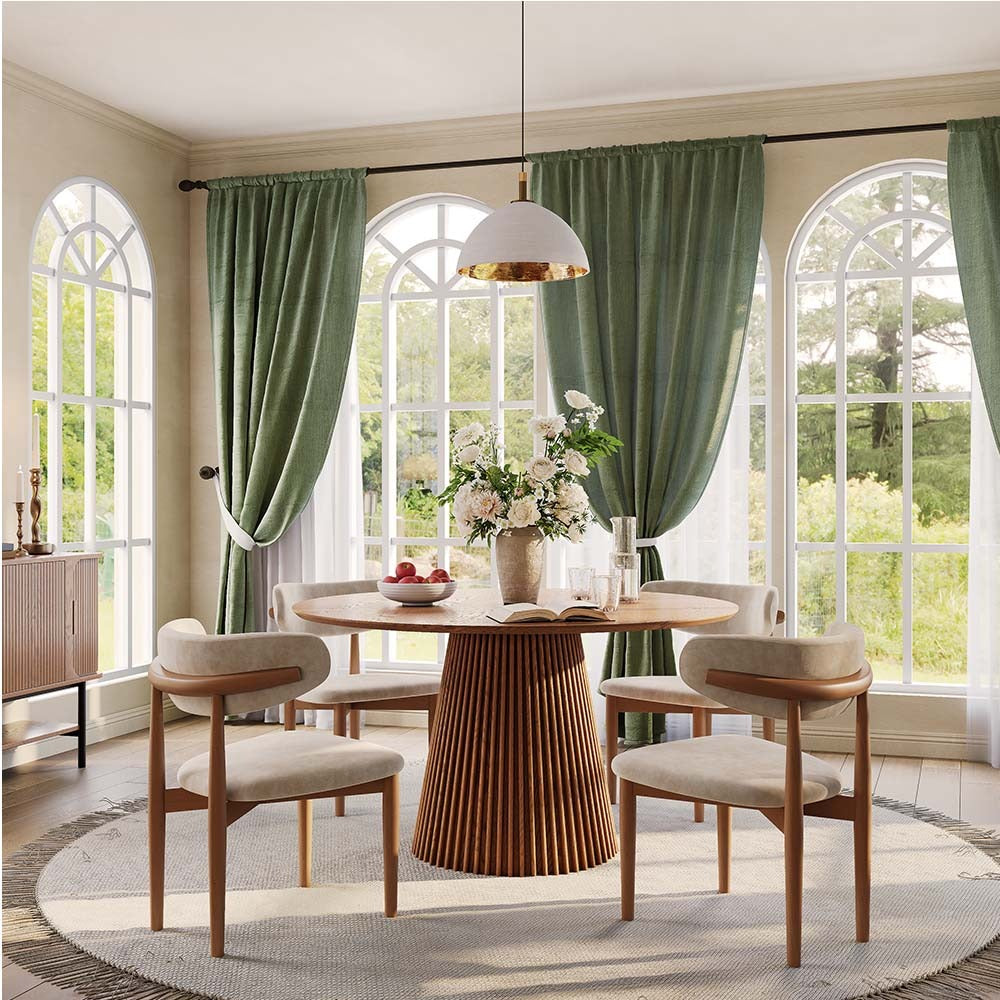 Round walnut-finish dining table in a bright dining room (chairs not included)