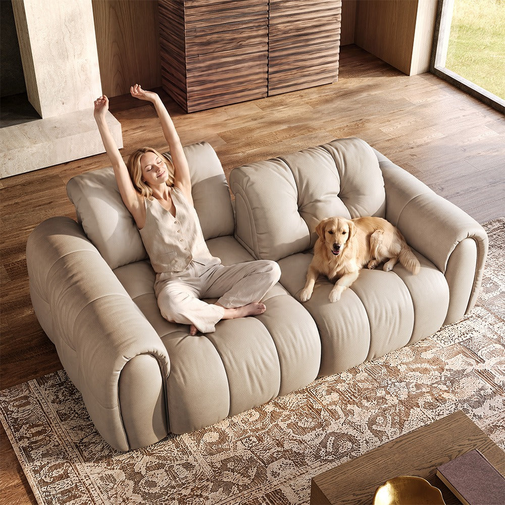 88-inch beige top-grain leather tufted modular sofa in a living room