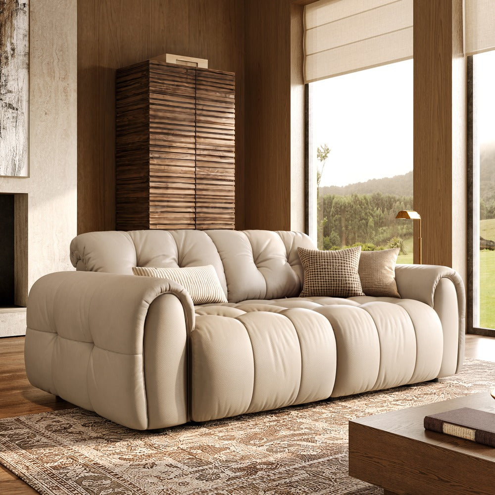 Beige leather tufted modular sofa with two armless seats and two armrests, front view in a living room