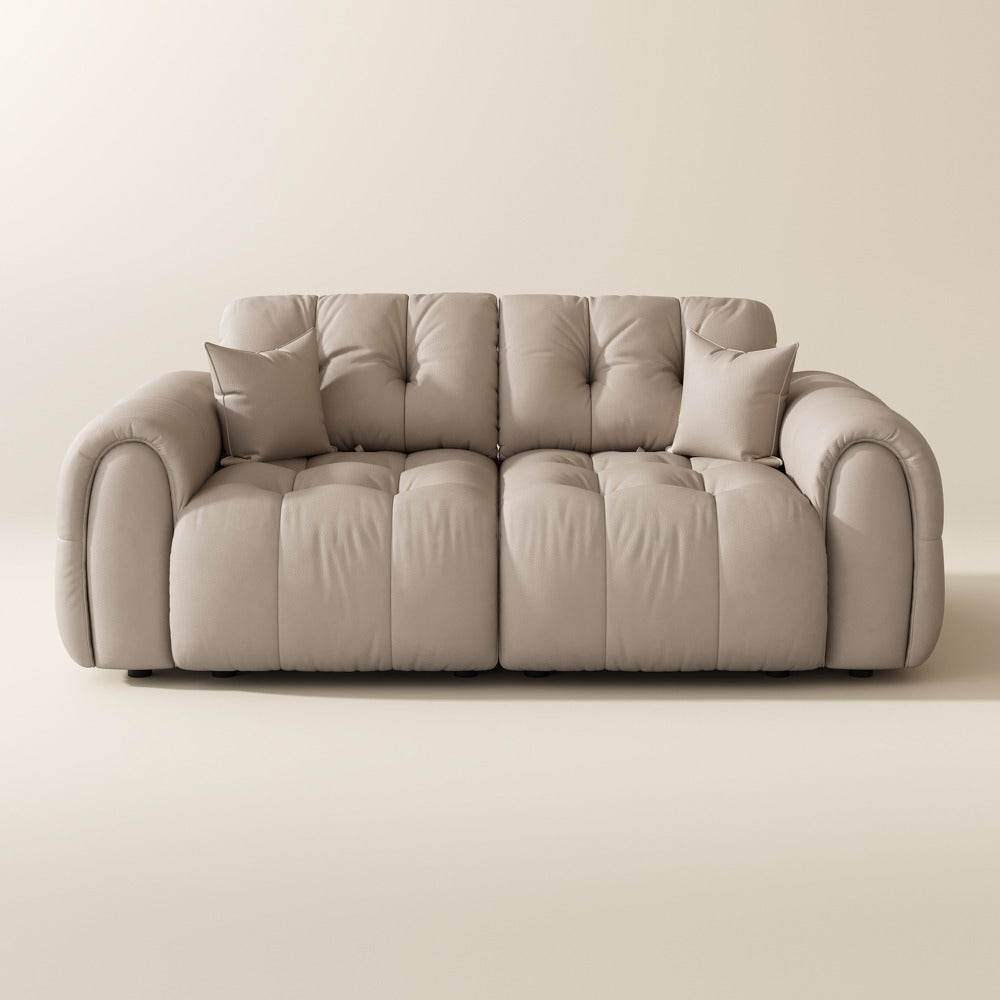 88-inch beige top-grain leather tufted modular sofa with pillows on a plain background