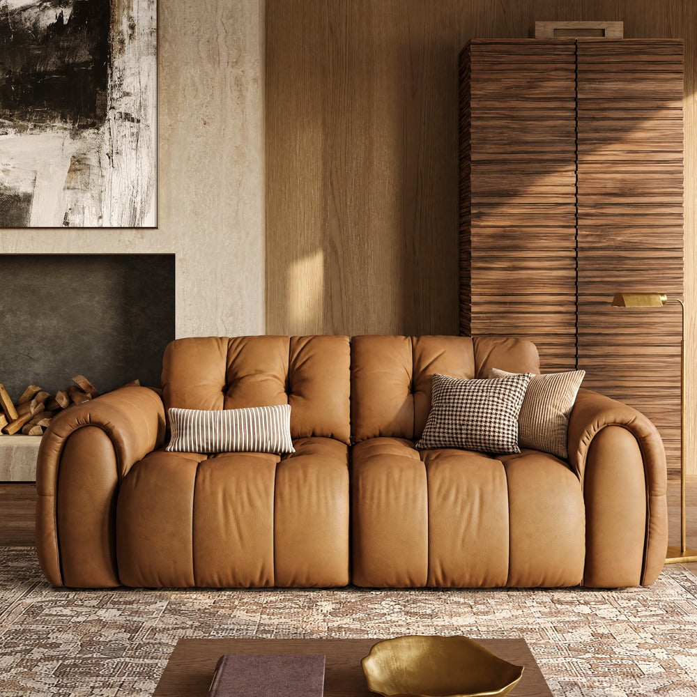 Brown leather tufted sofa in a living room, front view
