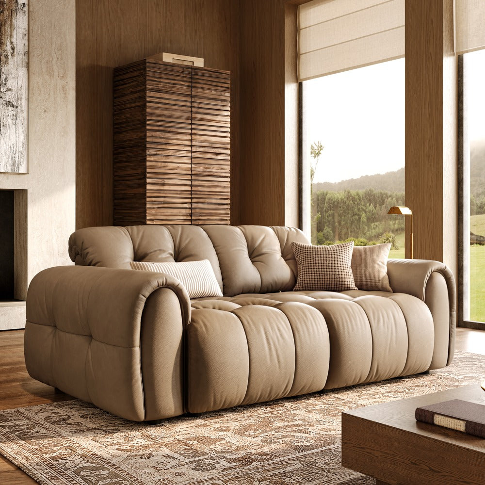 Khaki leather tufted modular sofa with two armless seats and two armrests, front view in a living room