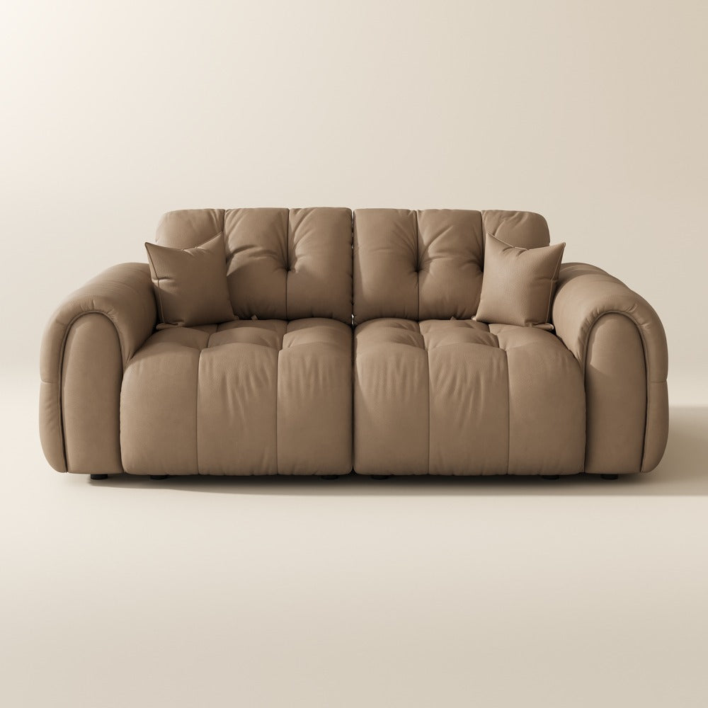 88-inch khaki top-grain leather tufted modular sofa with pillows on a plain background