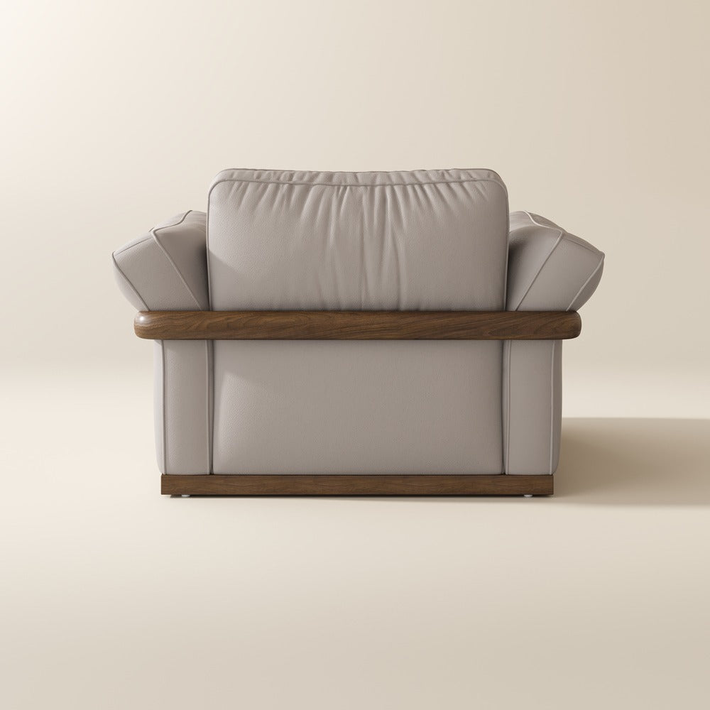 Beige leather accent chair, back view showing the solid wood frame