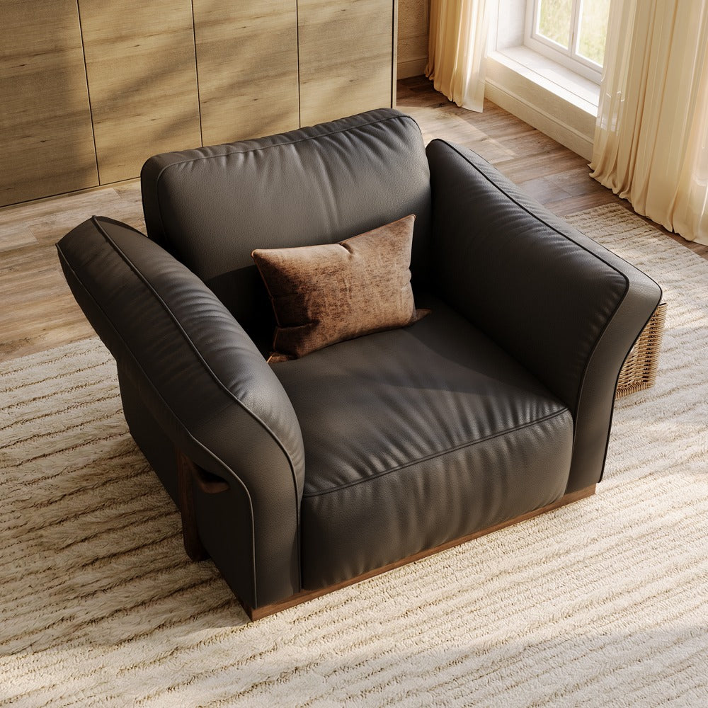 Black leather accent chair, angled view showing the curved armrests