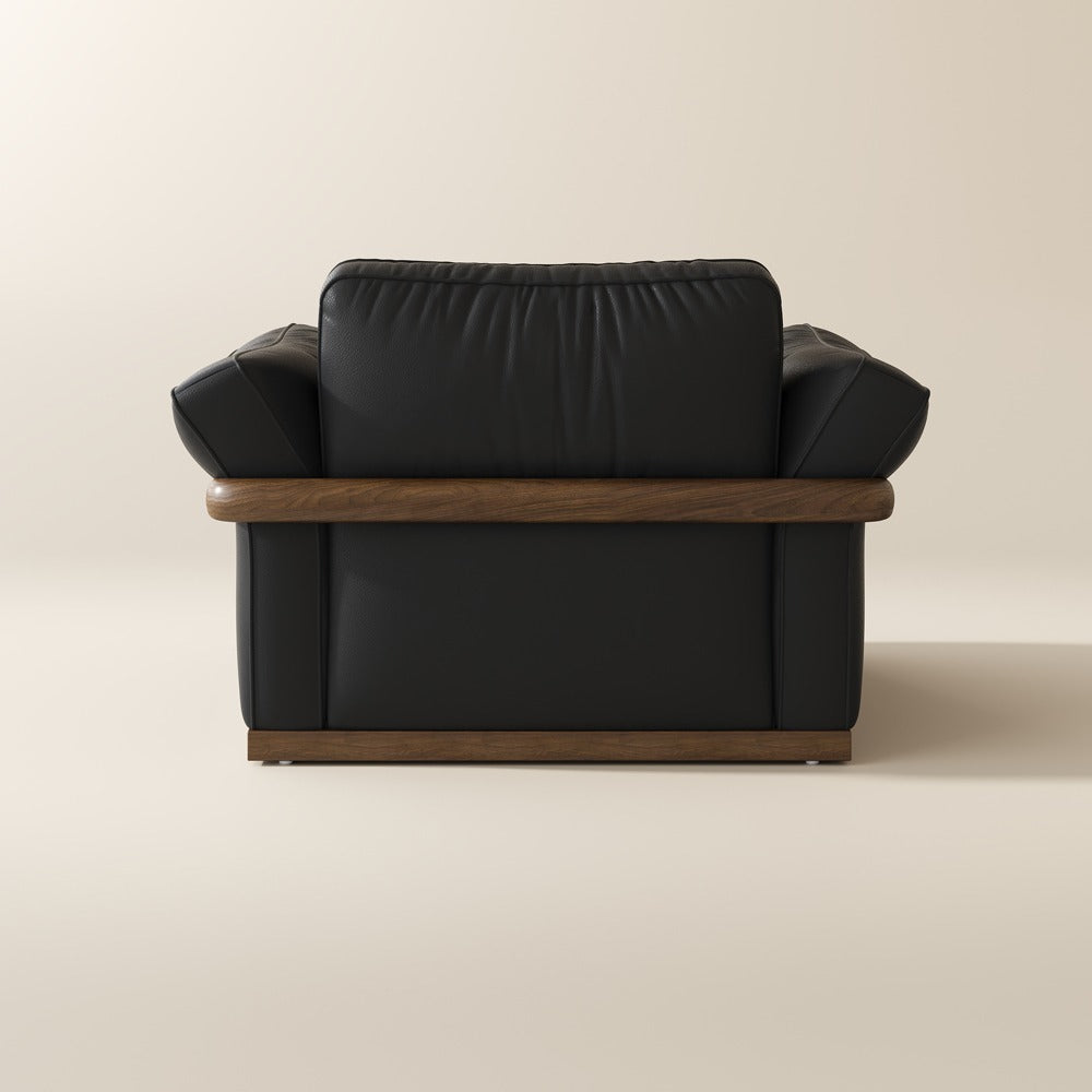 Black leather accent chair, back view showing the solid wood frame