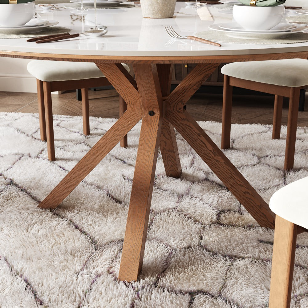 Walnut-tone crossed-leg base of the round dining table