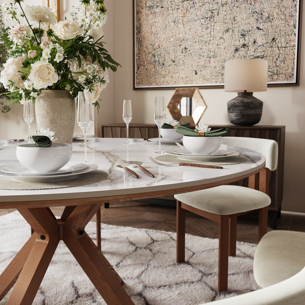 White round dining table styled with flowers and dinnerware
