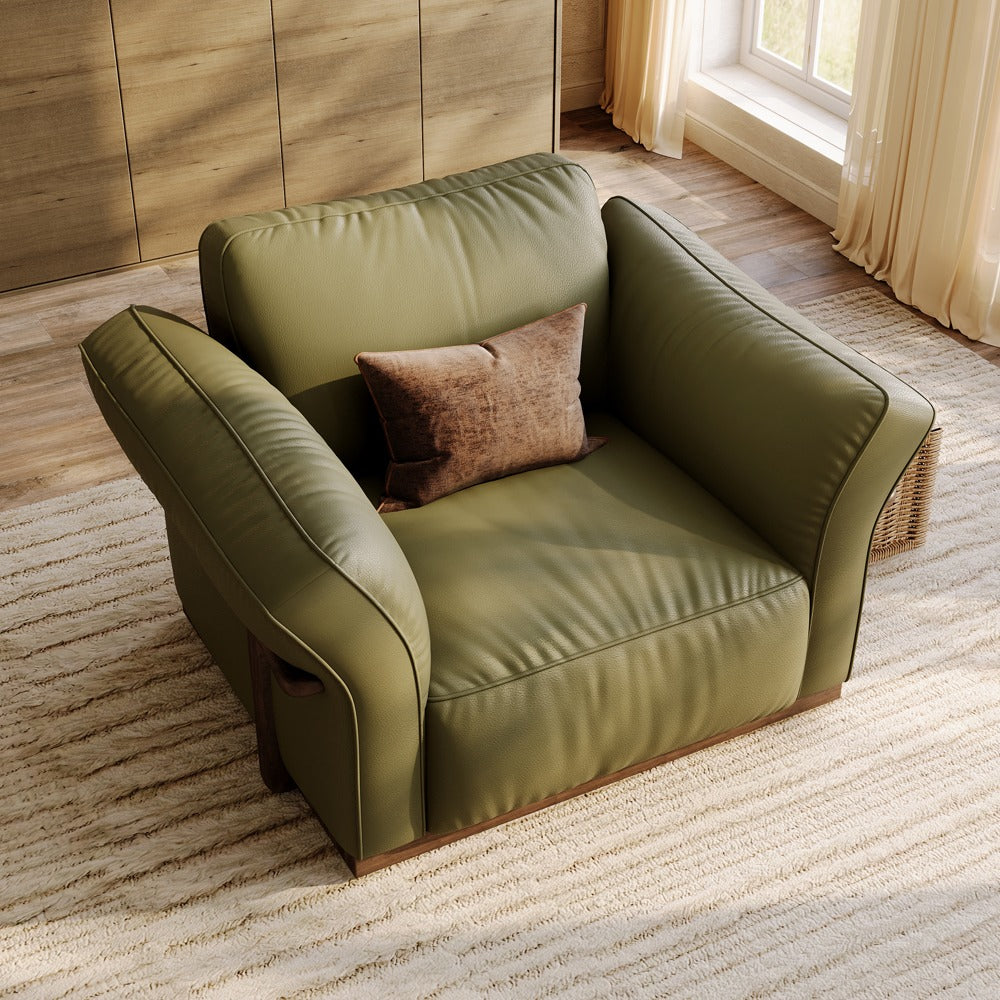 Green leather accent chair, angled view showing the curved armrests
