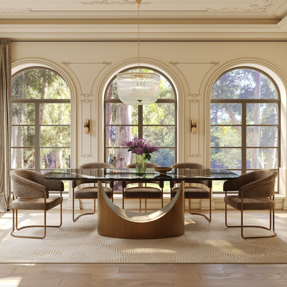Black marble rectangular dining table with bronze arch base, front view in a bright dining room (chairs not included)