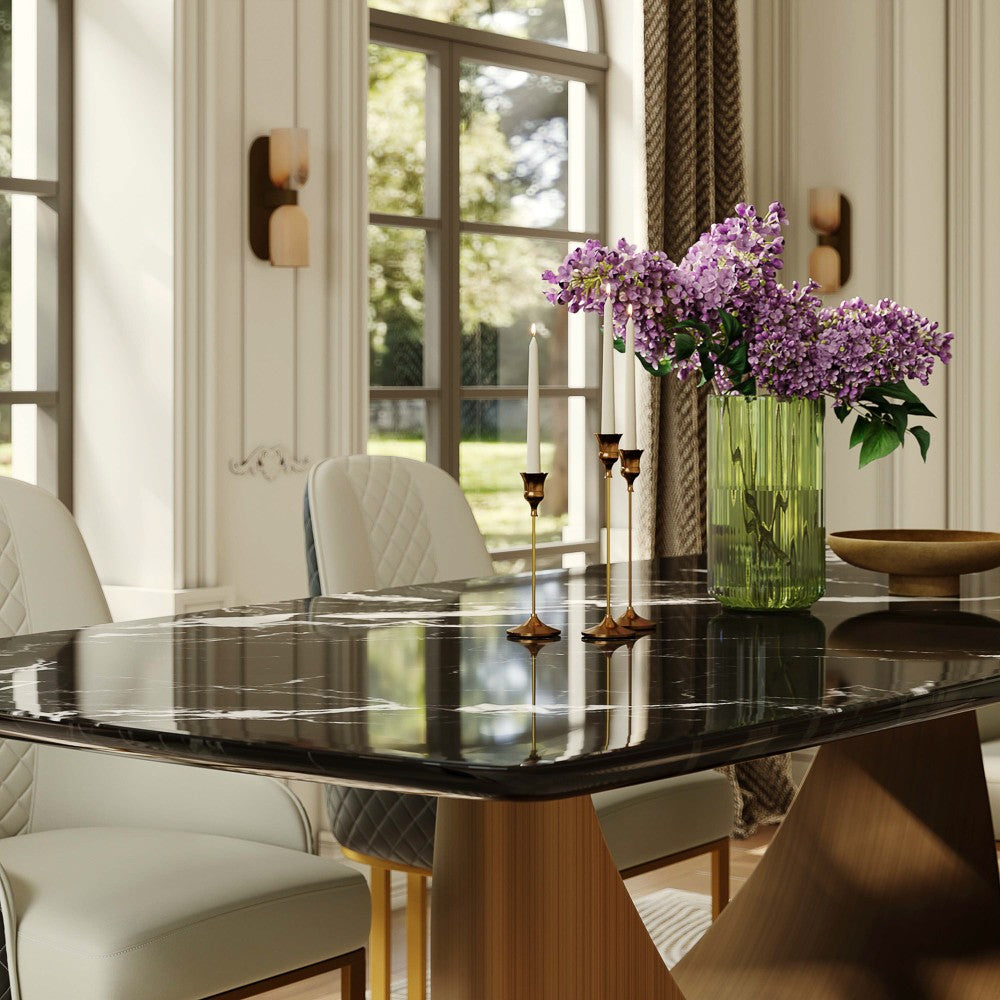Black marble tabletop with white veining and bronze base, close-up (chairs not included)