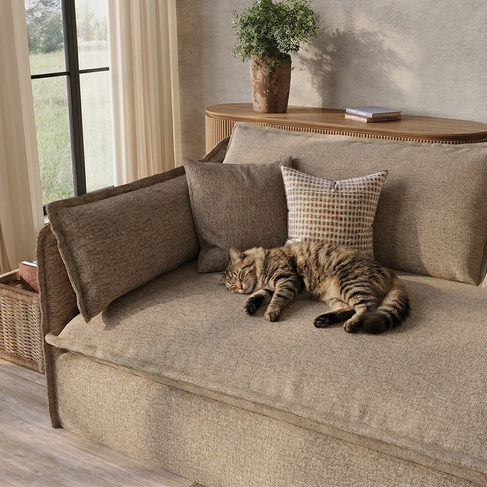 Close-up of khaki sofa seat with pillow-style armrest