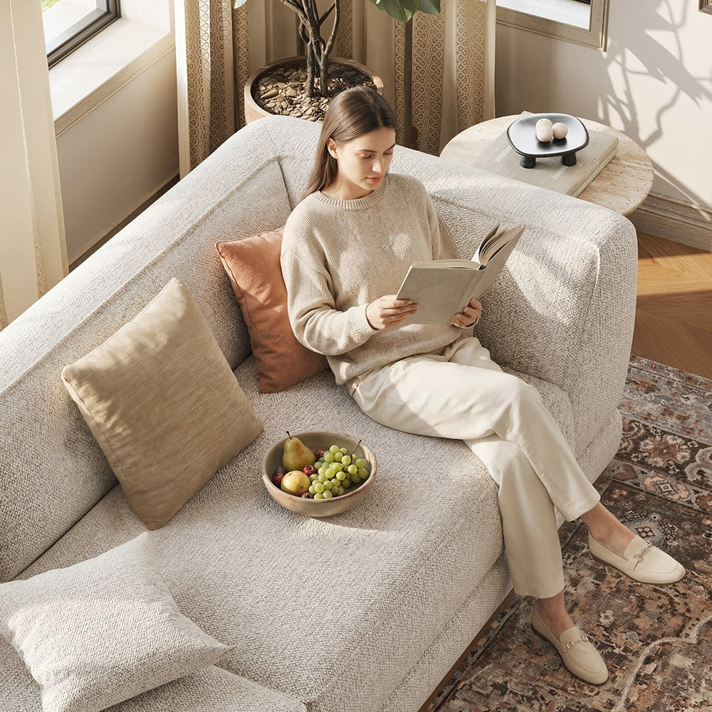 Relaxing on a light gray chenille sofa