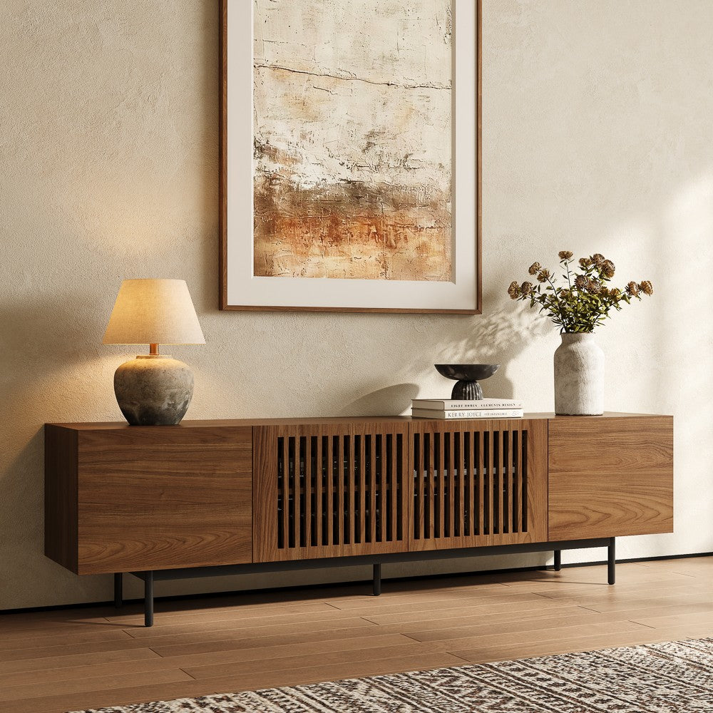 Walnut-color mid-century modern TV stand with slatted doors, angled view